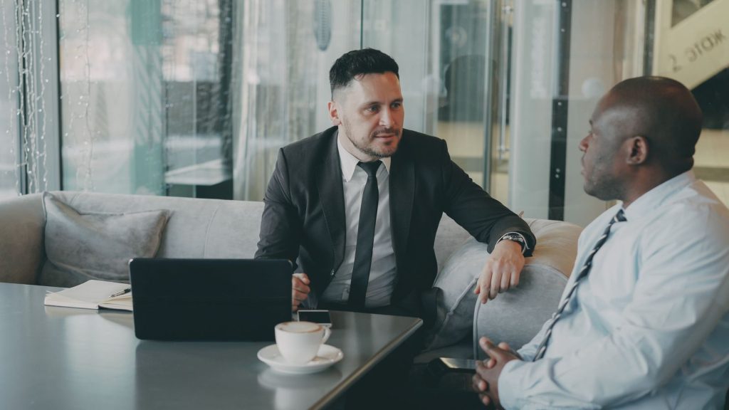 Resume consultant meeting with a client to discuss career goals over coffee